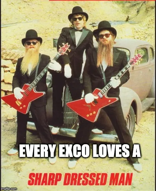 ZZ Top posed with guitars in black suits and hats, captioned “every exco loves a sharp dressed man”