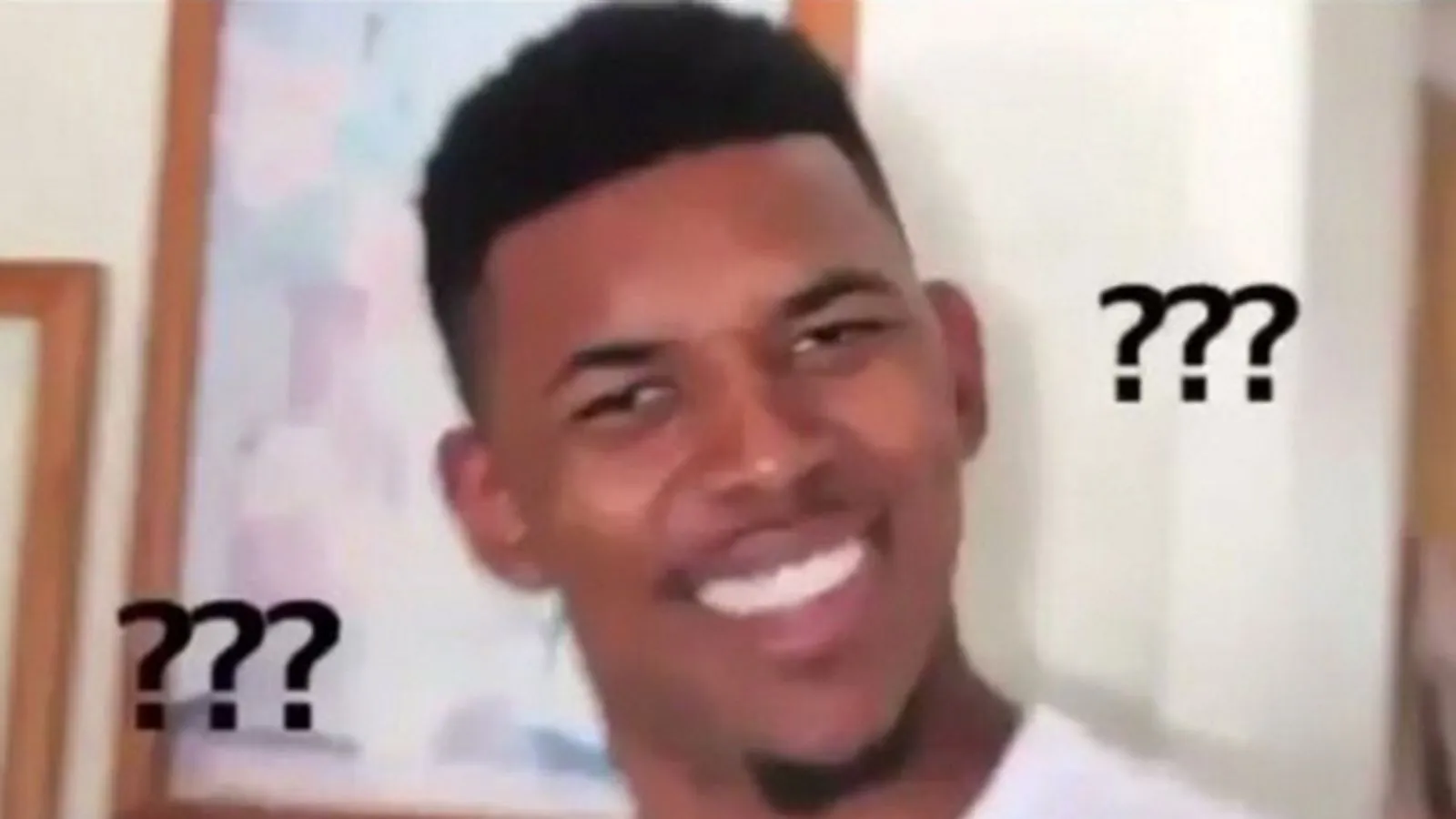 A man looking baffled, surrounded by question marks
