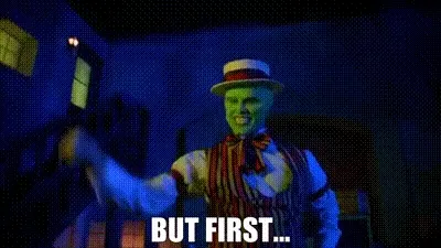 Jim Carrey as The Mask in a straw boater, captioned “but first…”