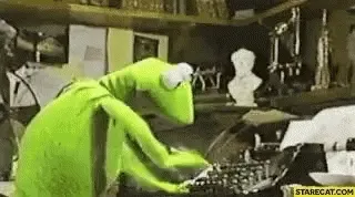 Kermit the Frog typing furiously at a typewriter